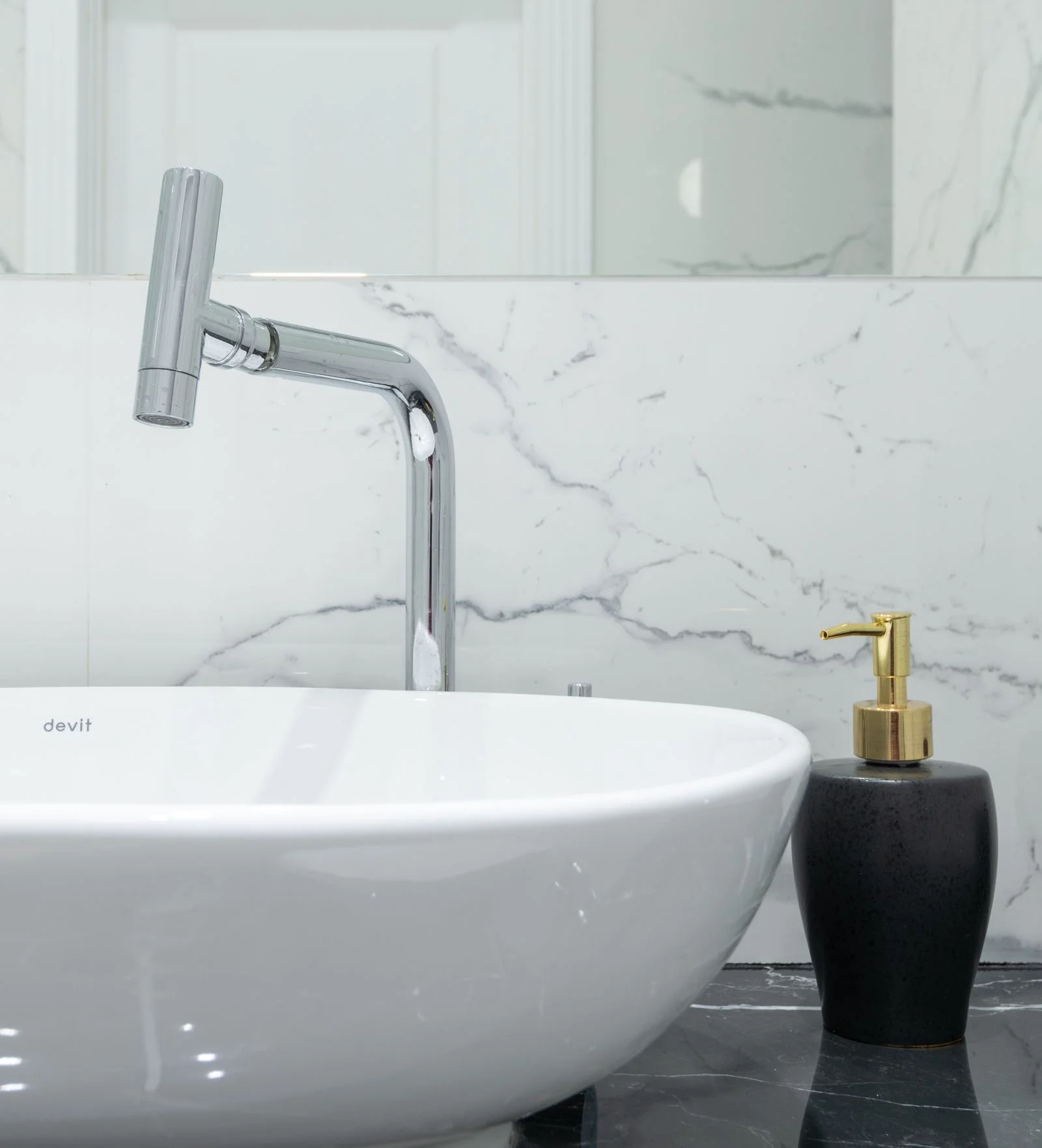Chrome restroom faucet and ceramic washbasin