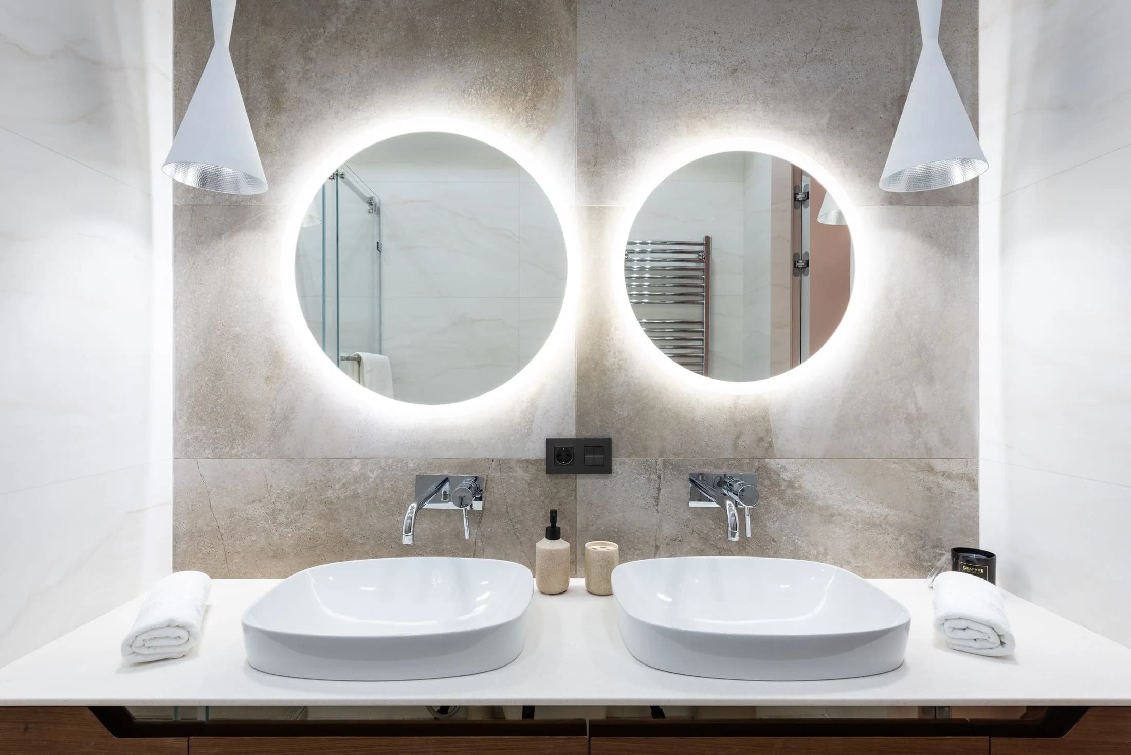 Installed restroom basins with wall-mounted faucets