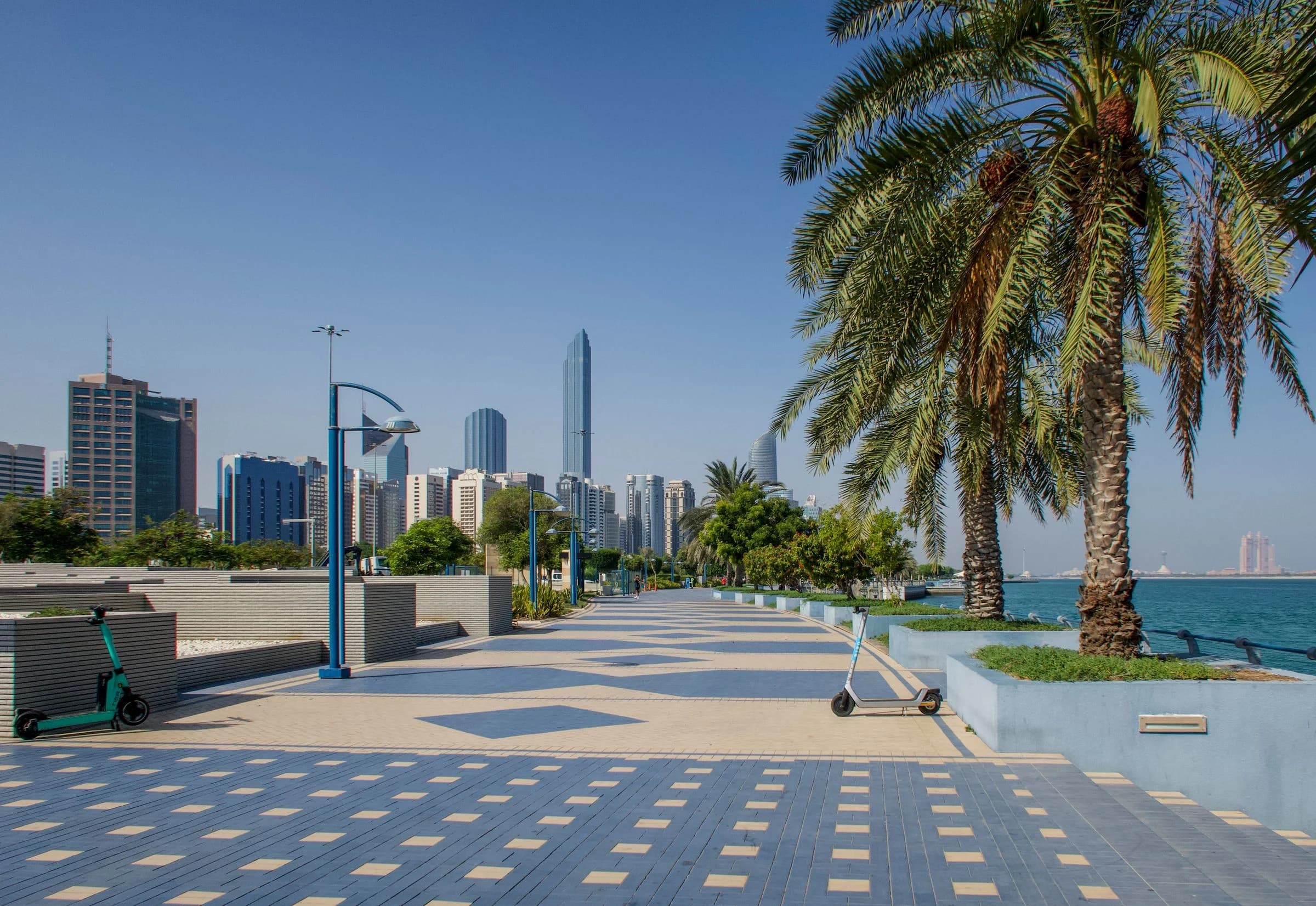 Maintained paving, palm trees and landscaped public grounds along the Abu Dhabi Corniche