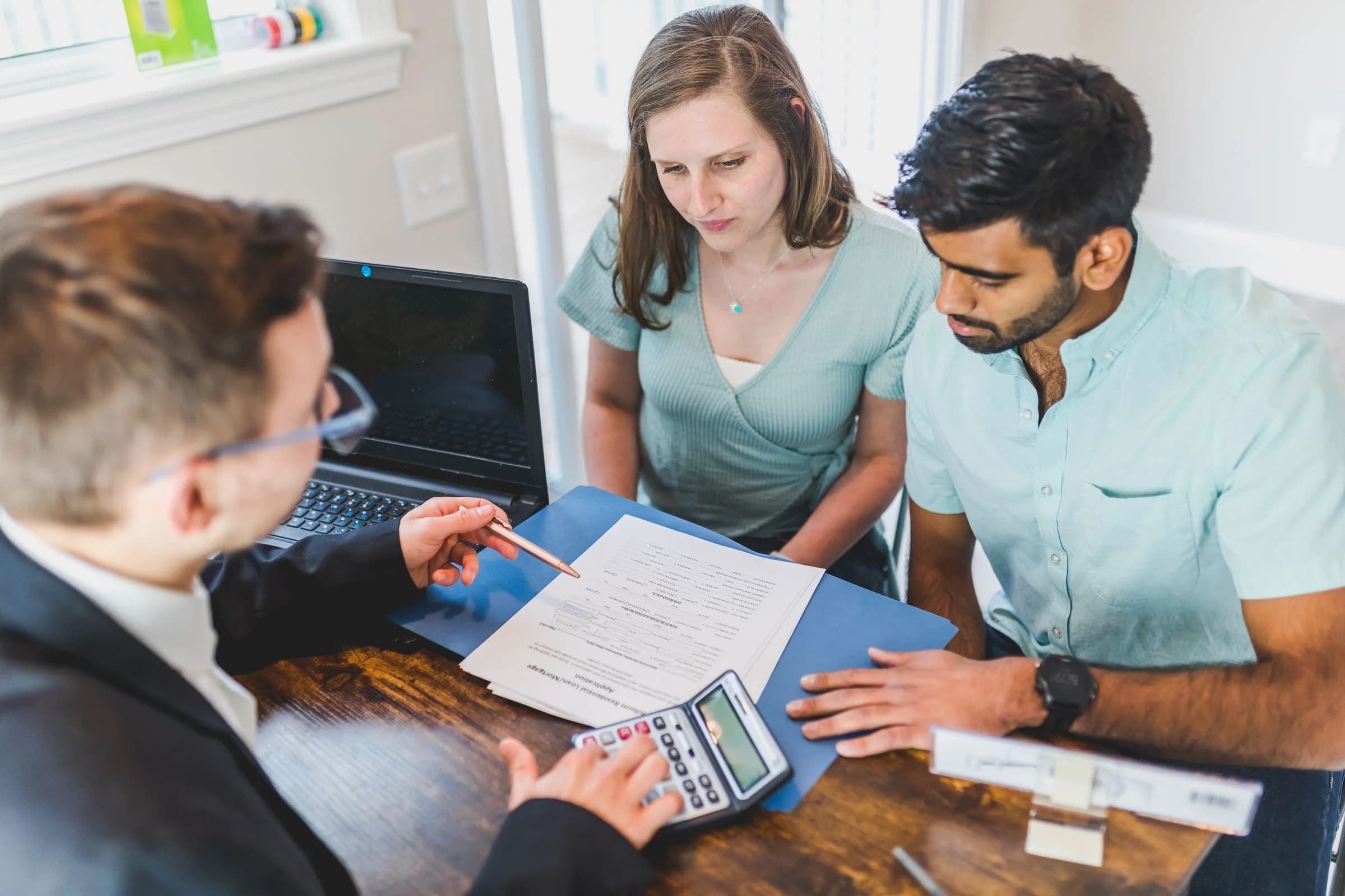 Property advisor reviewing agreement documents with clients