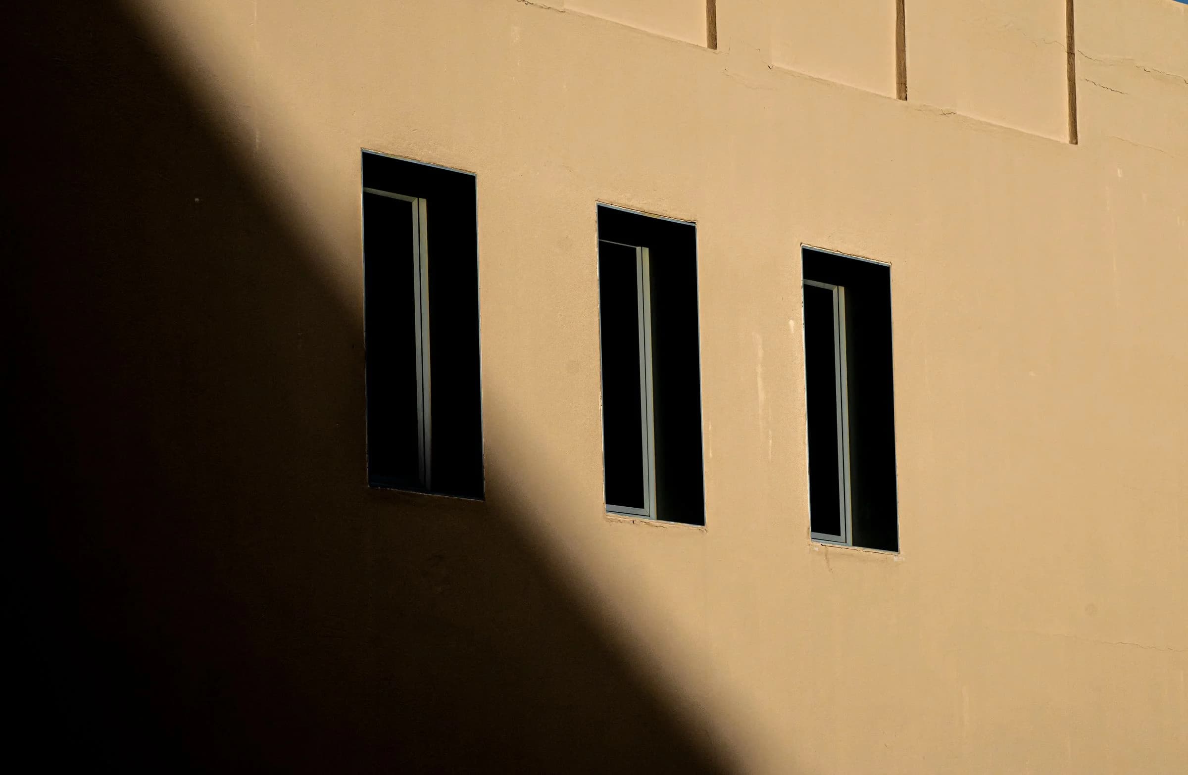 Sunlit building facade with windows in Abu Dhabi