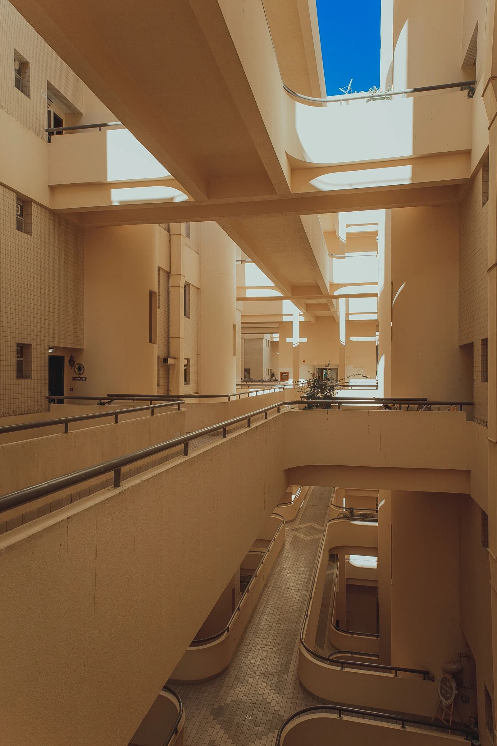 Shared corridors, railings and building surfaces in an Abu Dhabi residential atrium