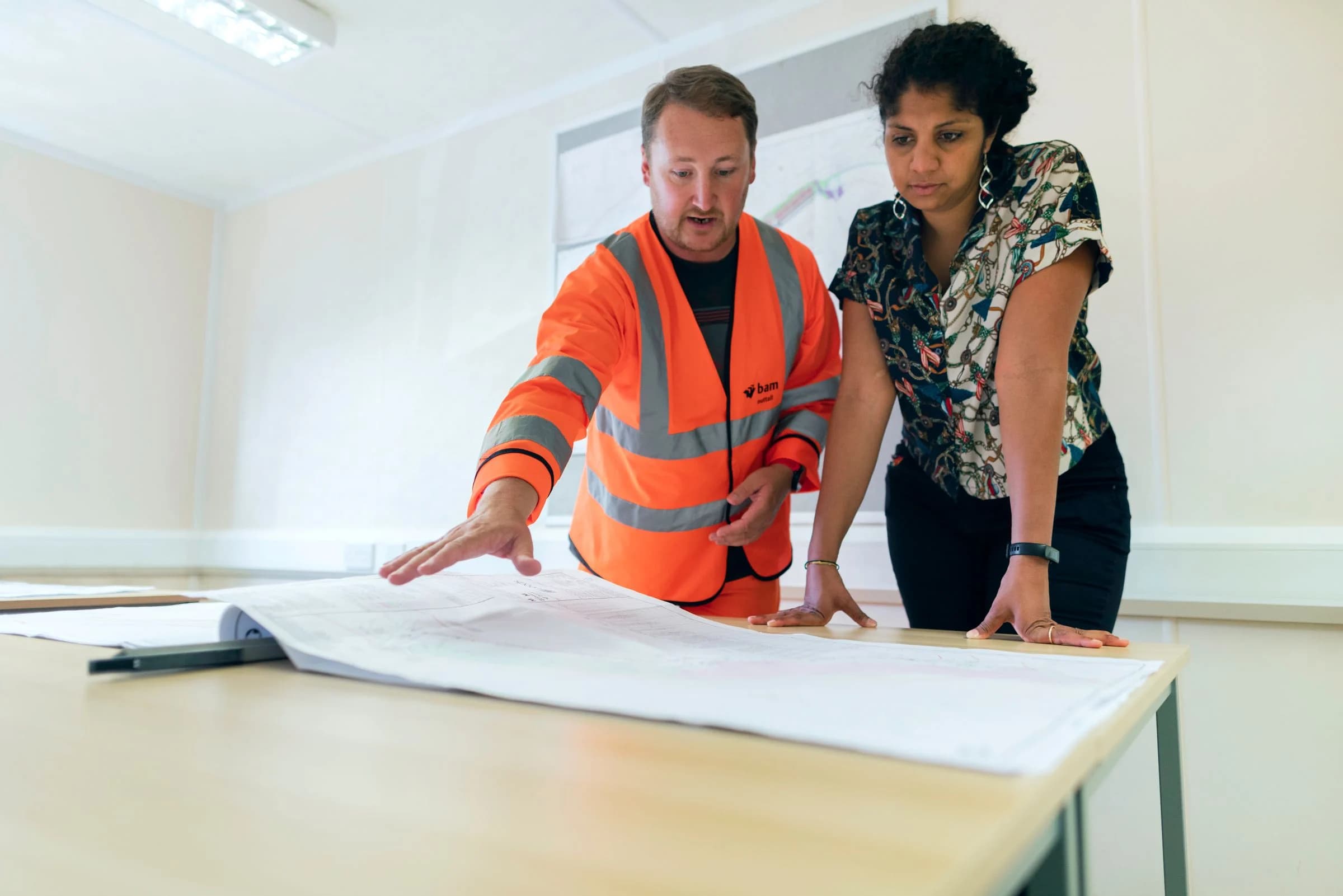 Technical service providers coordinating work over building plans