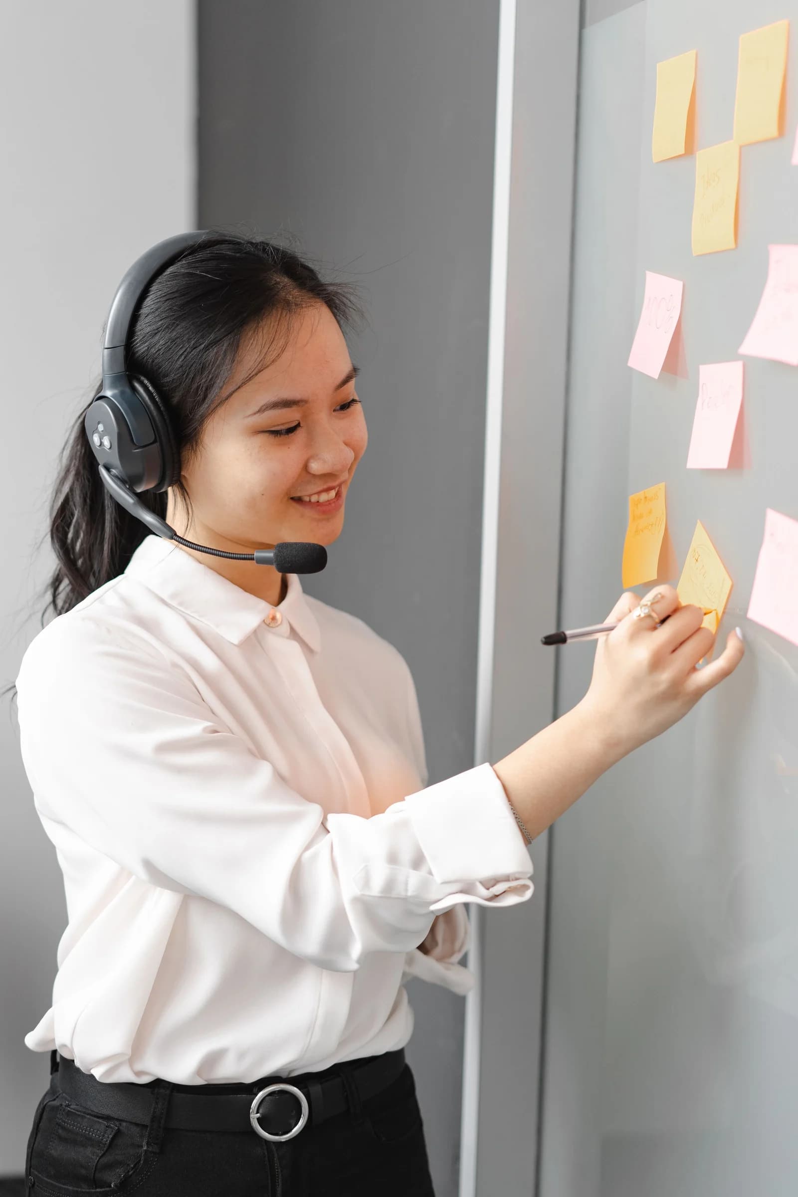 Support coordinator wearing a headset and recording follow-up notes