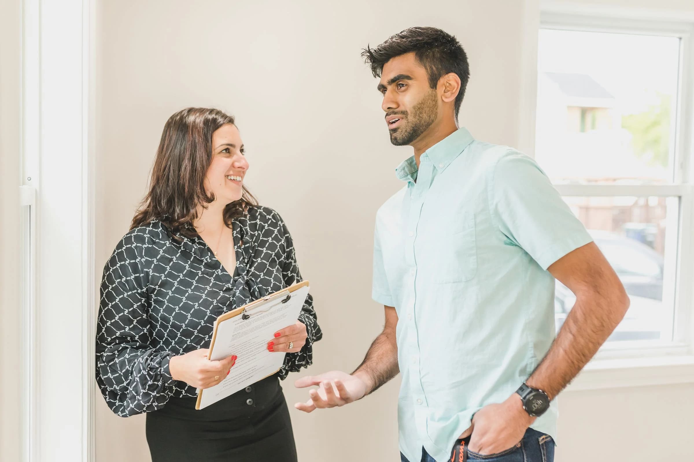 Property advisor and client discussing requirements during an apartment visit