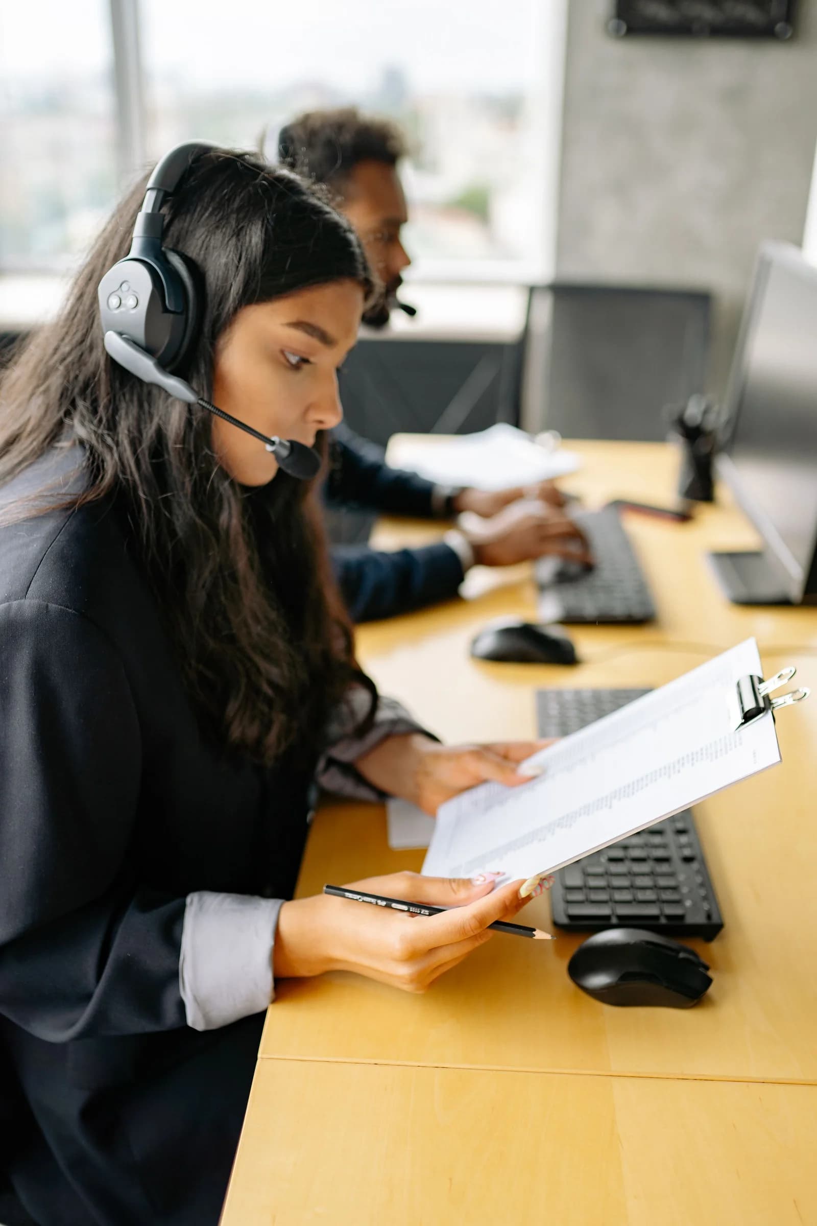 Support advisor reviewing documents while wearing a headset